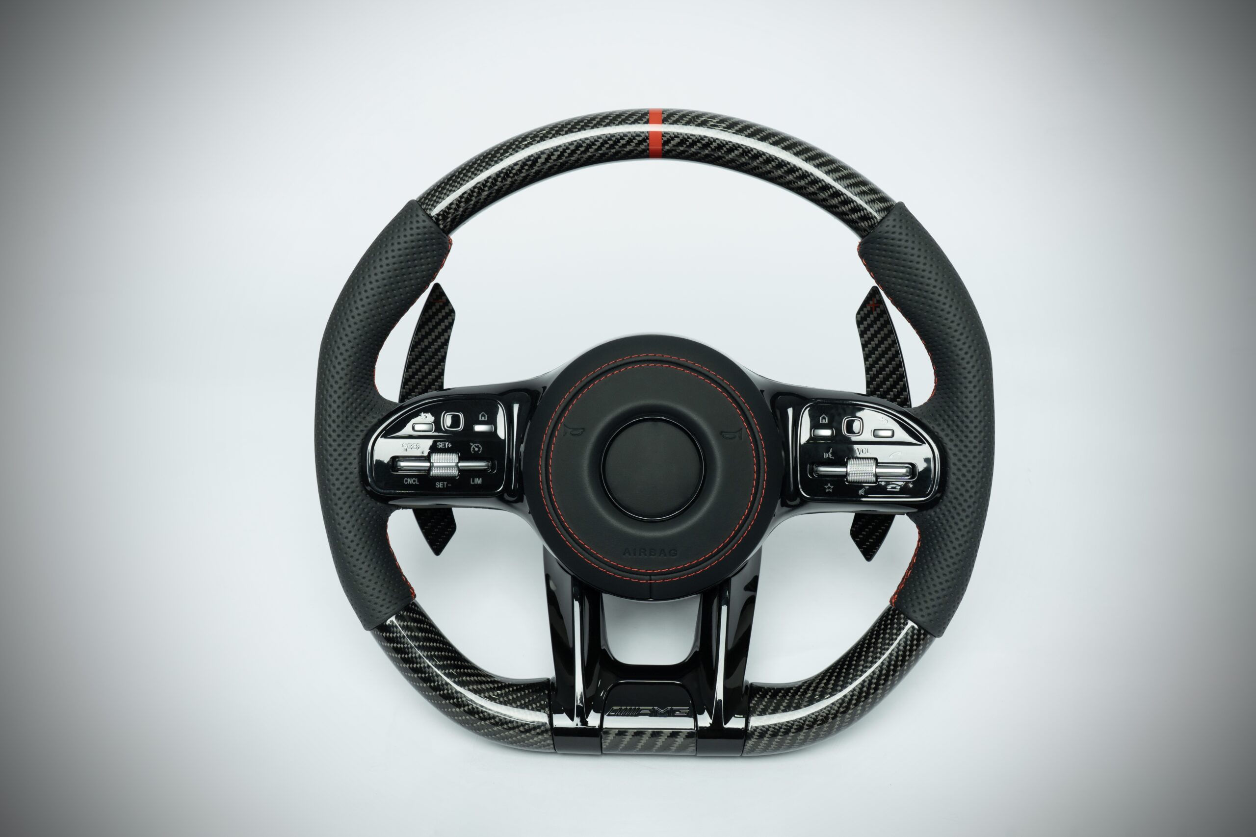 Mercedes Benz carbon fiber steering wheel with red marker and red stiching on perforated leather grip