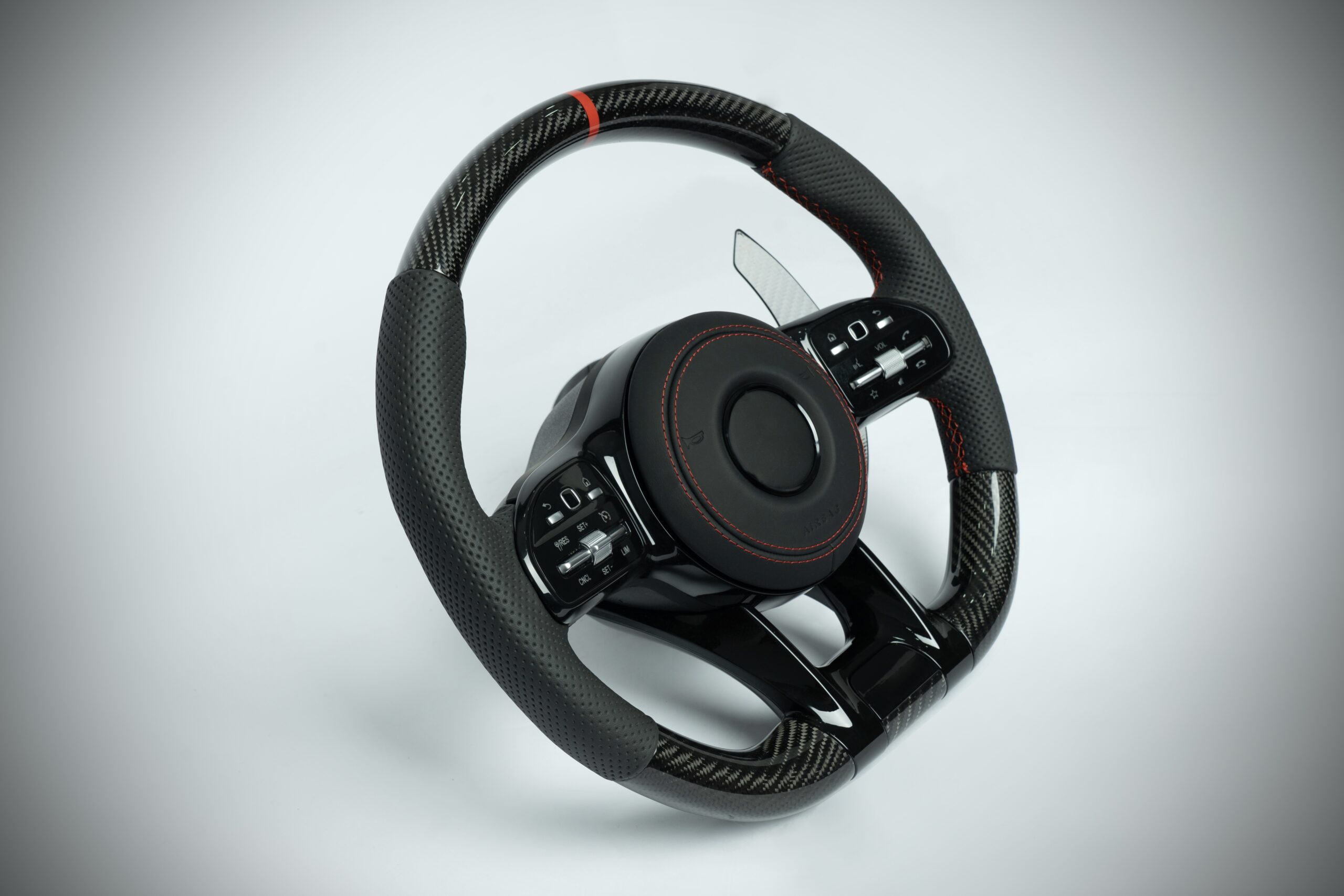 Mercedes Benz carbon fiber steering wheel with red marker and red stiching on perforated leather grip - Image 4