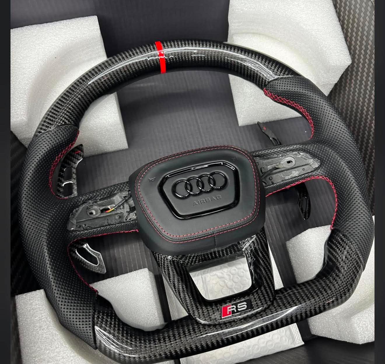 2021 Audi Rs5 , Full carbon fiber, Heated, vibrate, perforated sport leather grip,red stitching,red center strip, RS logo at the bottom.