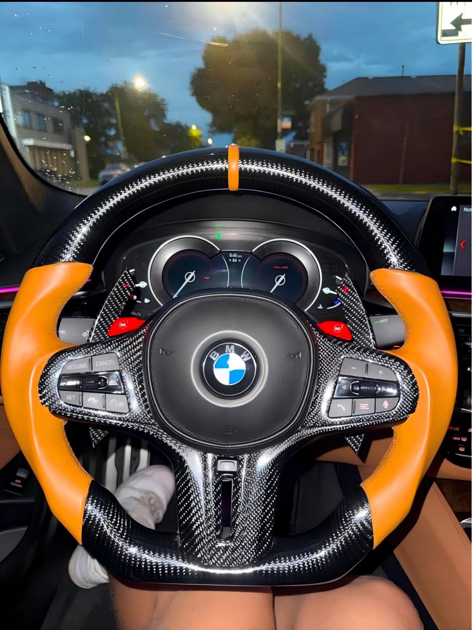 Pricing: $700.00 (item) + $80.46 (shipping) = $780.46 (total); 50% deposit ($350.00)2021 BMW 540i (G30) | Specifications: BMW G-Series M Sport steering wheel; carbon fiber at 12 and 6 o'clock positions; brown leather center stripe; full carbon fiber trim panel; extended carbon fiber paddle shifters; brown sporty genuine leather grips; brown stitching; includes ID8-style buttons; supports heating and vibration functions; M badge at the bottom.
