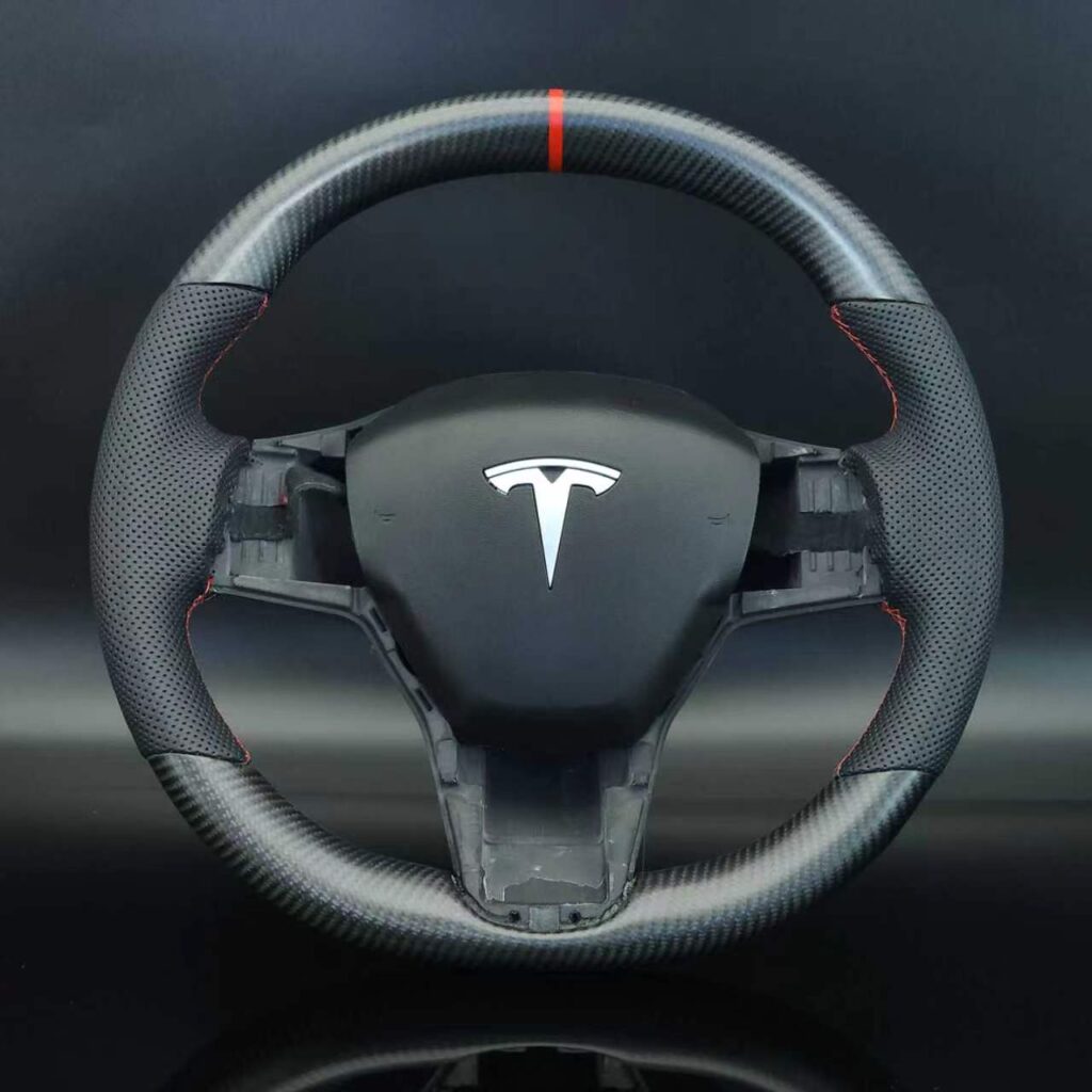 Tesla Matte Carbon fiber perforated leather grip with red stitching and center strip.